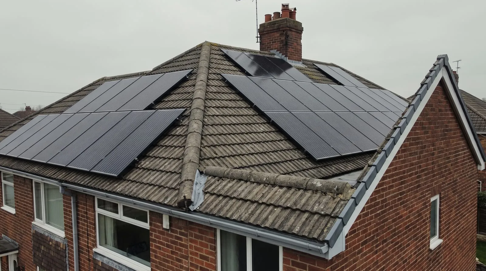 Solar panels on two slopes of a hipped tile roof